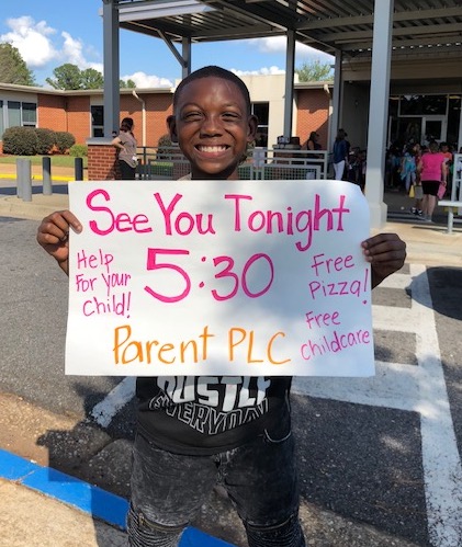 Student with See you Tonight sign, for Parent Engagement Program